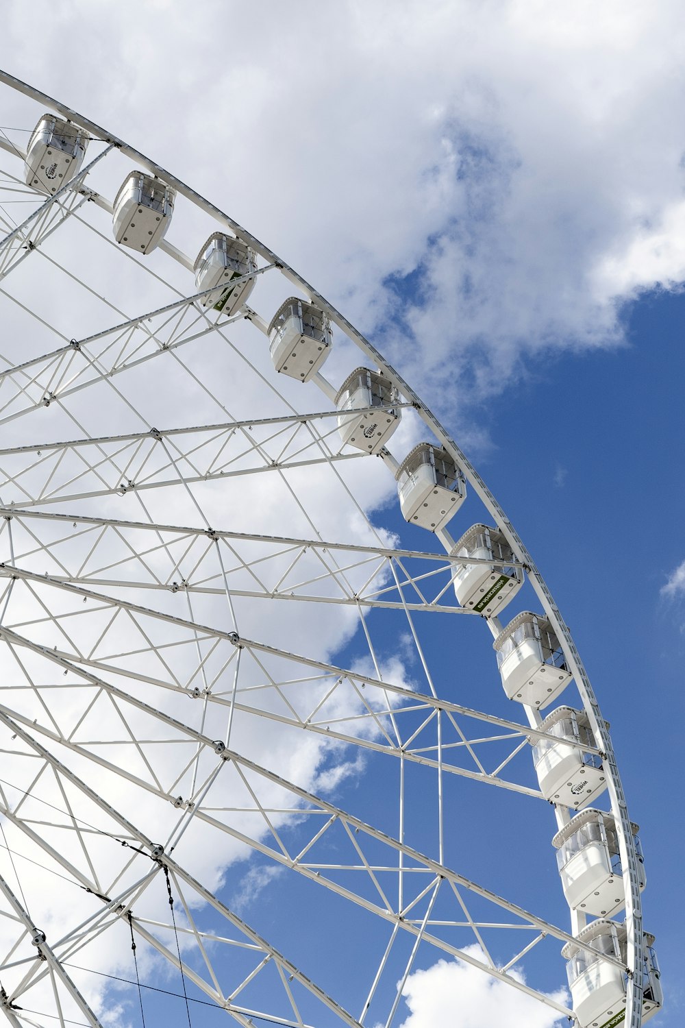 a large white ferris wheel on a cloudy day