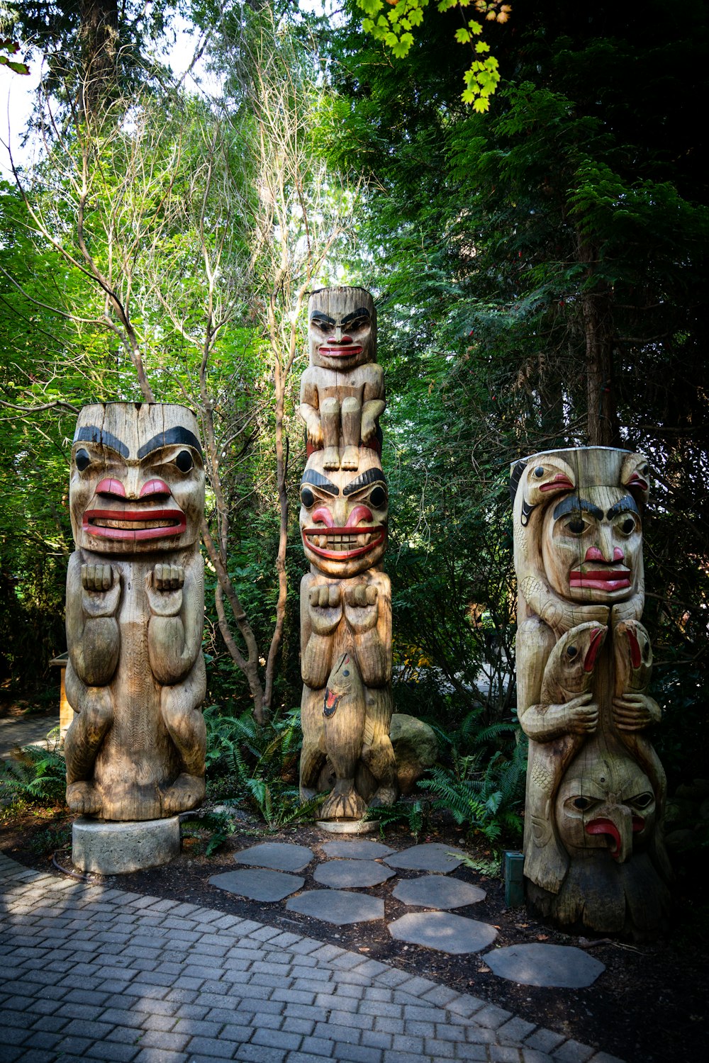 a couple of totems sitting on top of a stone walkway