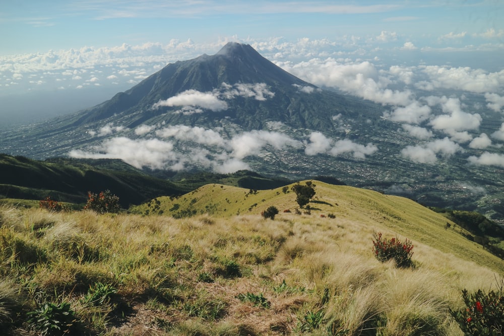 a view of a mountain with clouds in the sky