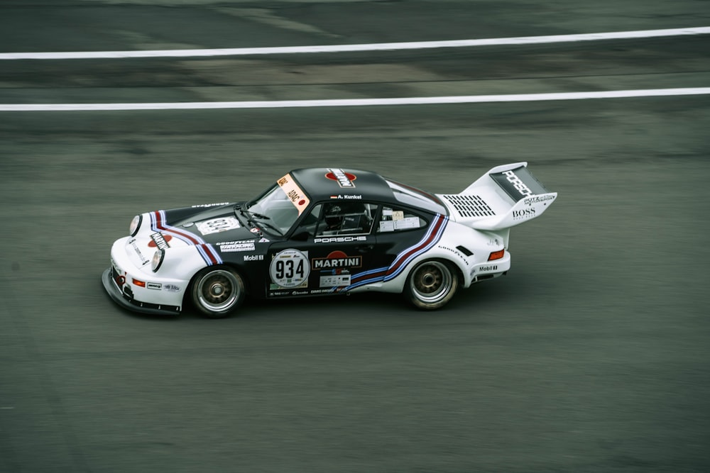 a white car driving down a race track