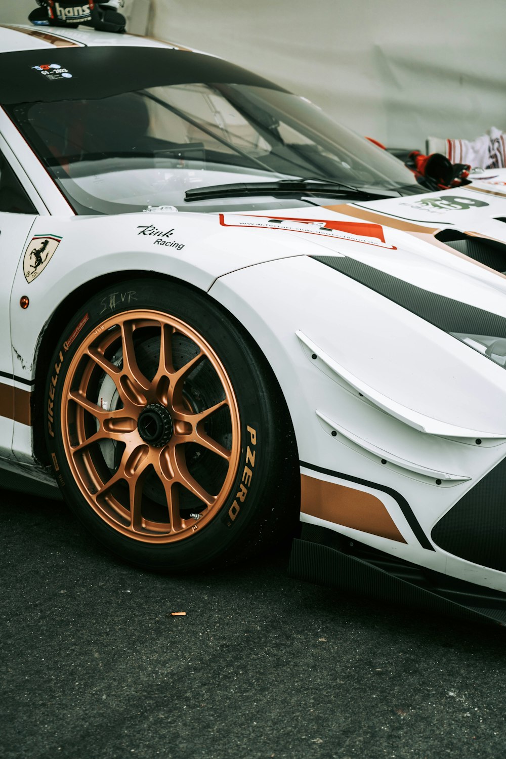 a white and orange sports car parked in a parking lot