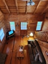 Living area inside the family cabin with wooden furniture and cozy lighting.