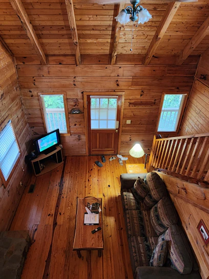 An inviting interior shot of a wendy house featuring natural wood finishes and cozy furnishings.