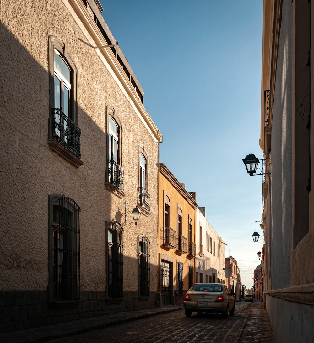 a car is parked on a cobblestone street