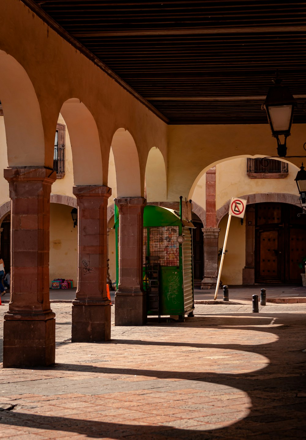 a building with arches and a clock on the side of it