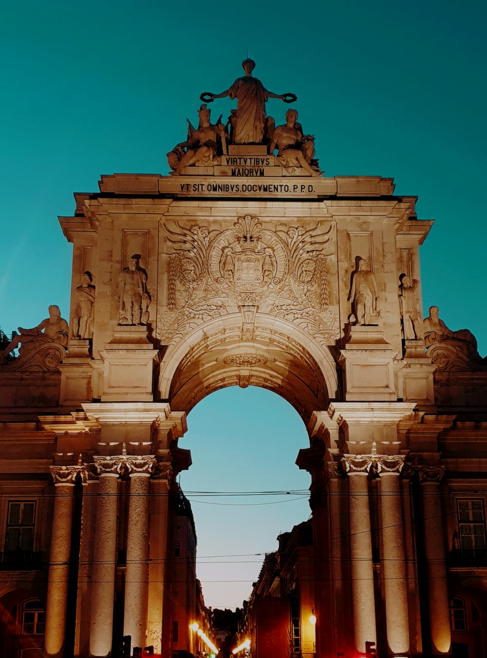 a large arch with a statue on top of it