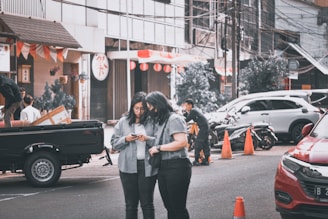 A busy truck driver checking his load details on a mobile device at a logistics hub.
