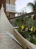 Private balcony with hammock surrounded by tropical greenery.