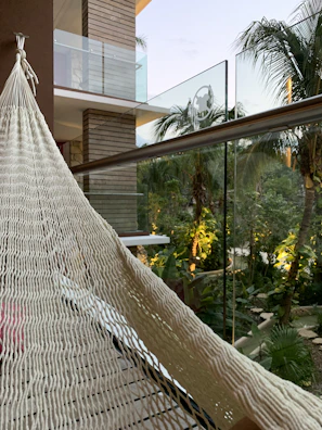 Private balcony with hammock surrounded by tropical greenery.