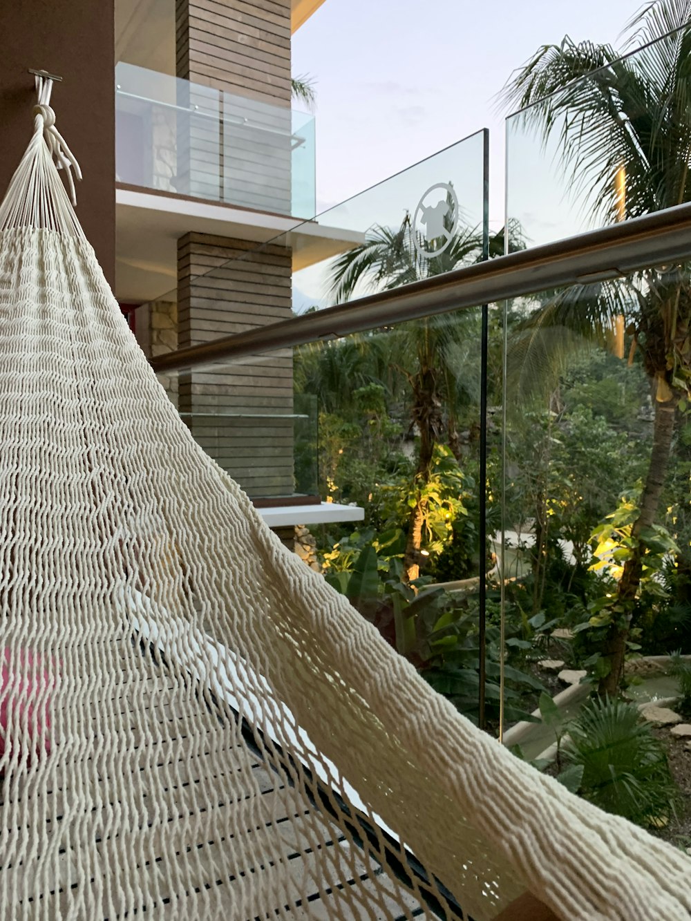 a white hammock hanging from a balcony