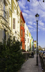 a row of colorful buildings along a sidewalk