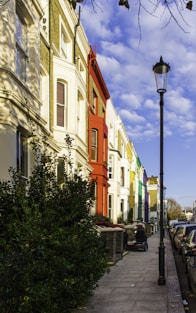 a row of colorful buildings along a sidewalk