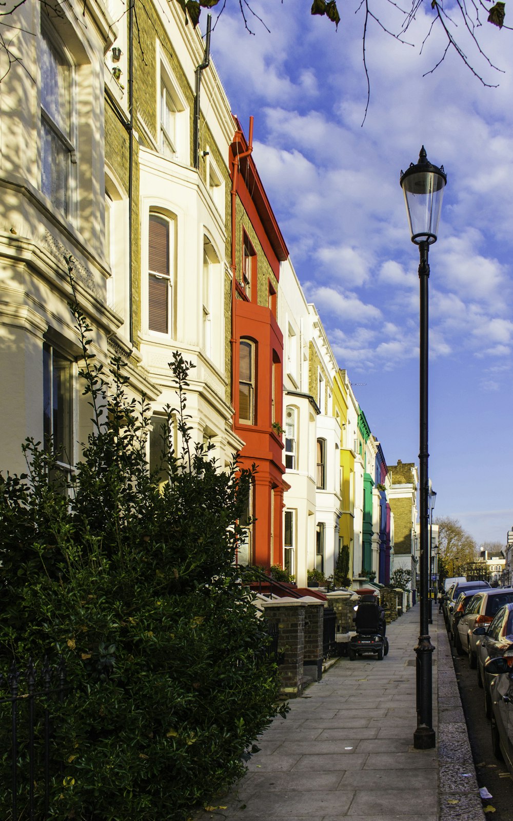 a row of colorful buildings along a sidewalk