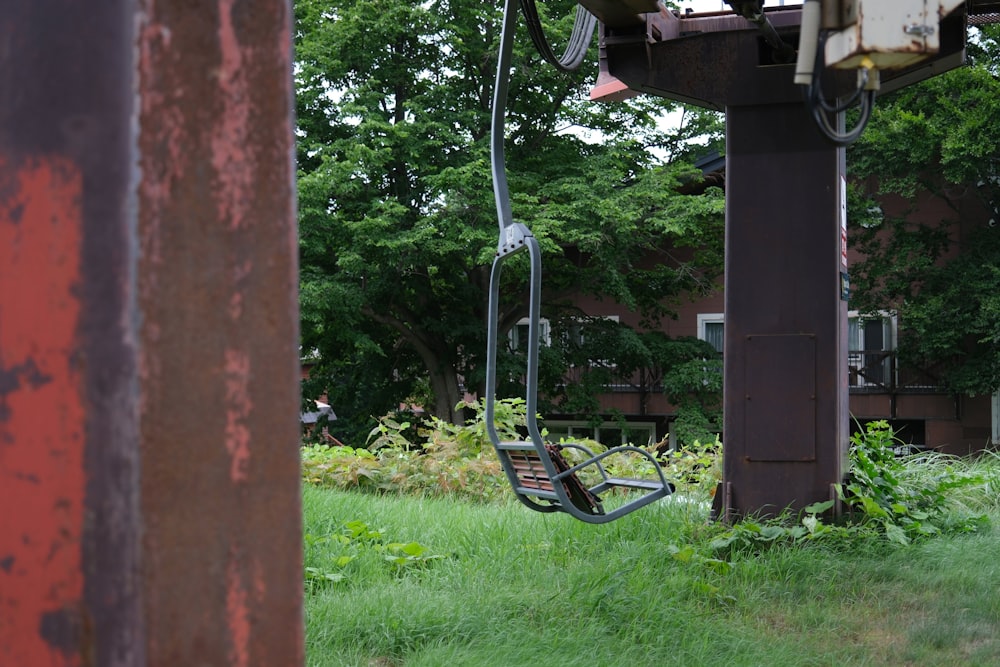 a swing in the grass near a building