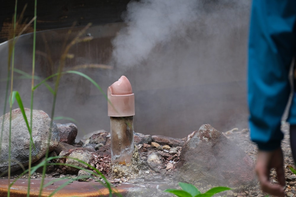 a person standing in front of a hot spring