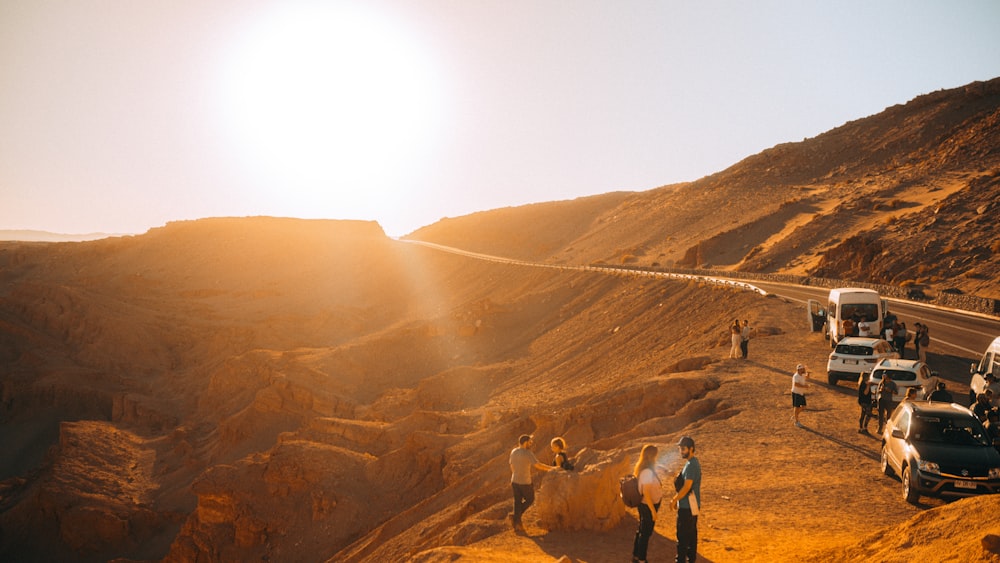 a group of people standing on the side of a road