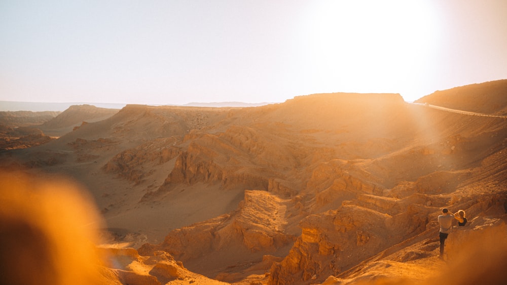 a couple of people standing on top of a mountain