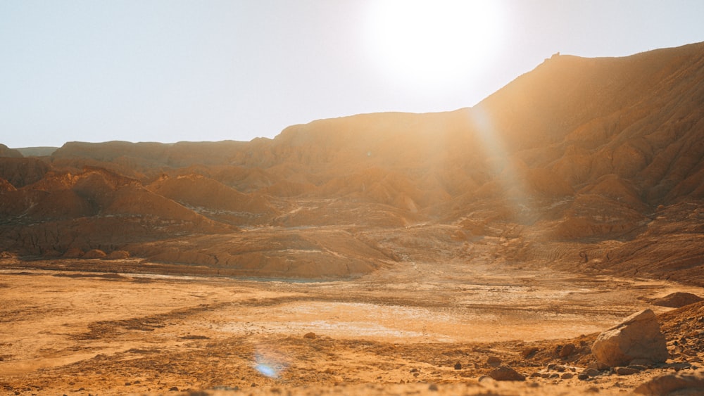 the sun shines brightly over a desert landscape