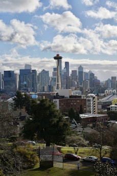 A vibrant cityscape showcasing the skyline of Seattle alongside traditional architecture from Daejeon, symbolizing cultural connection.