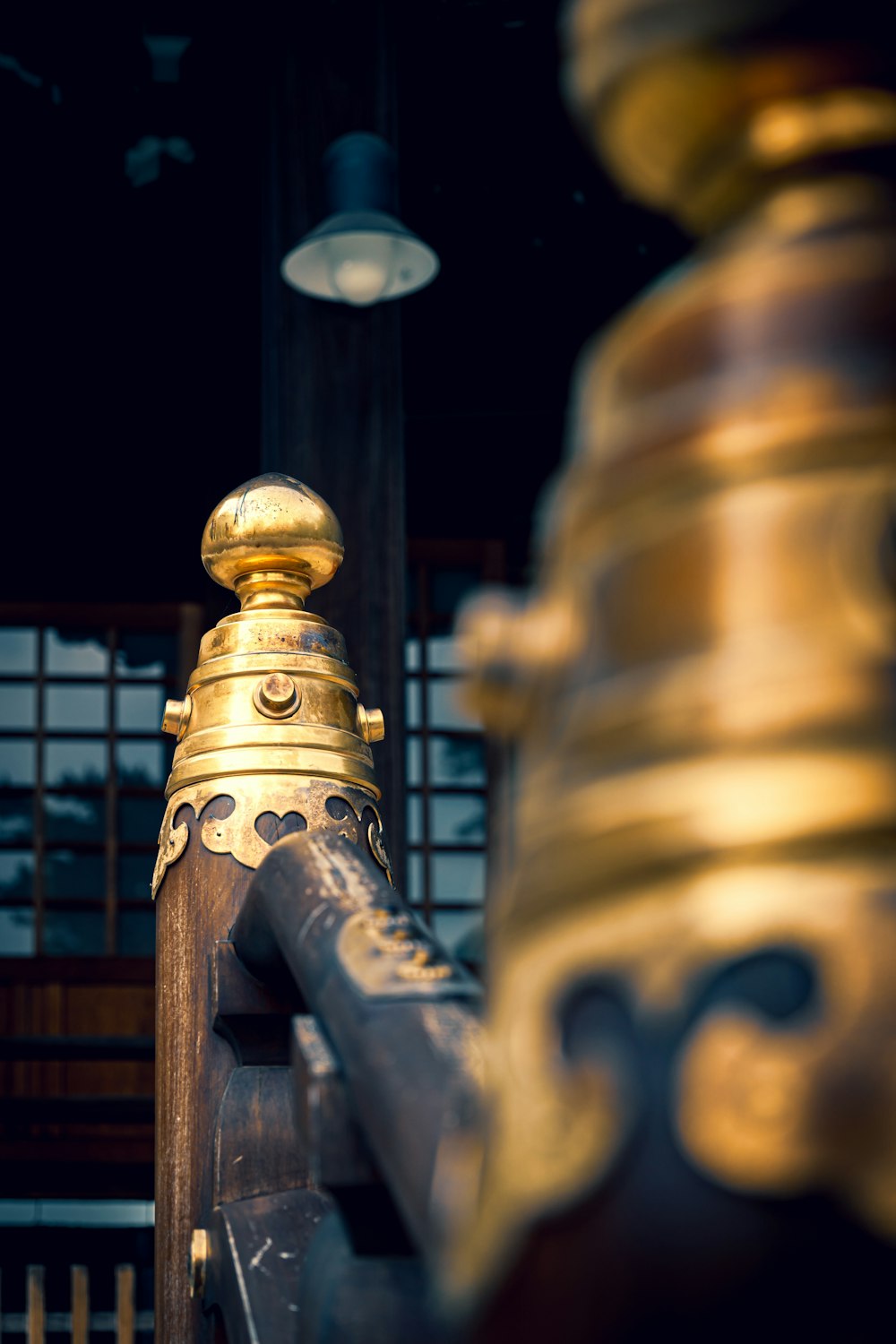 a close up of a metal pole with a light in the background