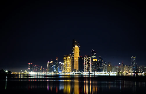 A cinematic nighttime city skyline with golden lights reflecting innovation and success.