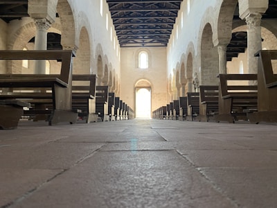 Interior of a traditional synagogue with wooden benches and Torah ark.