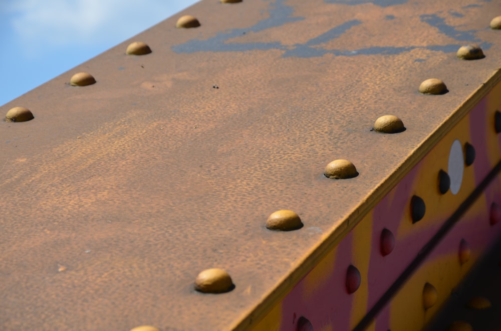 a close up of a metal structure with lots of rivets