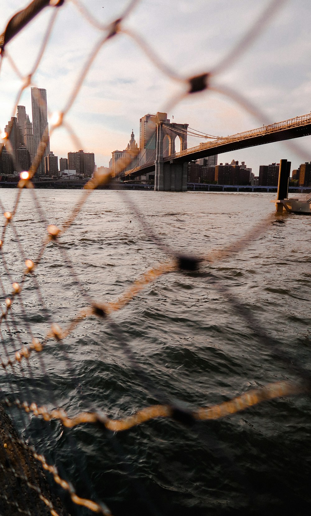 a body of water with a bridge in the background