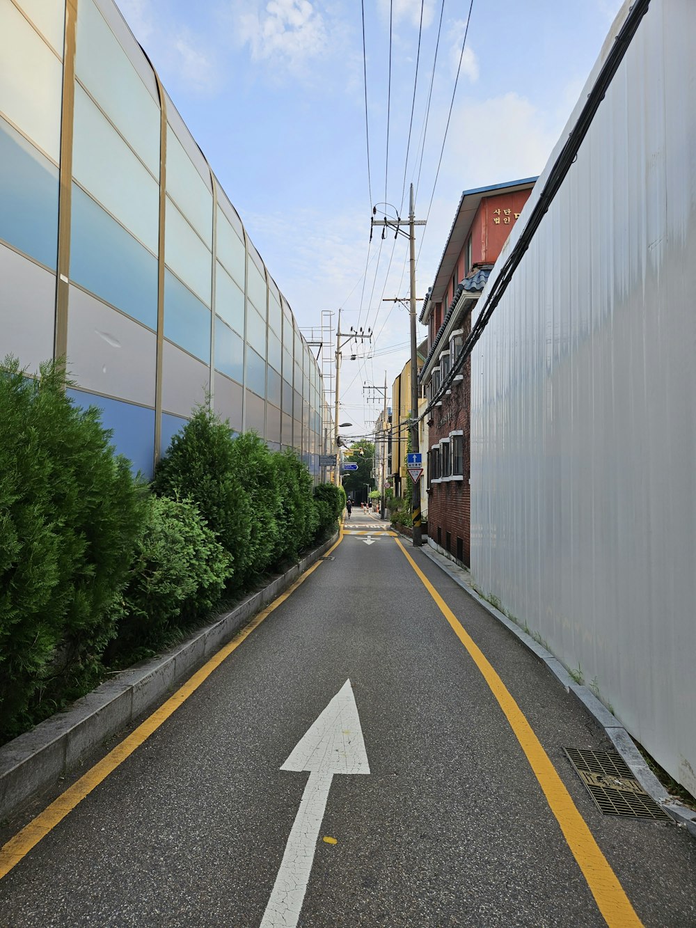 a street with a white arrow painted on it