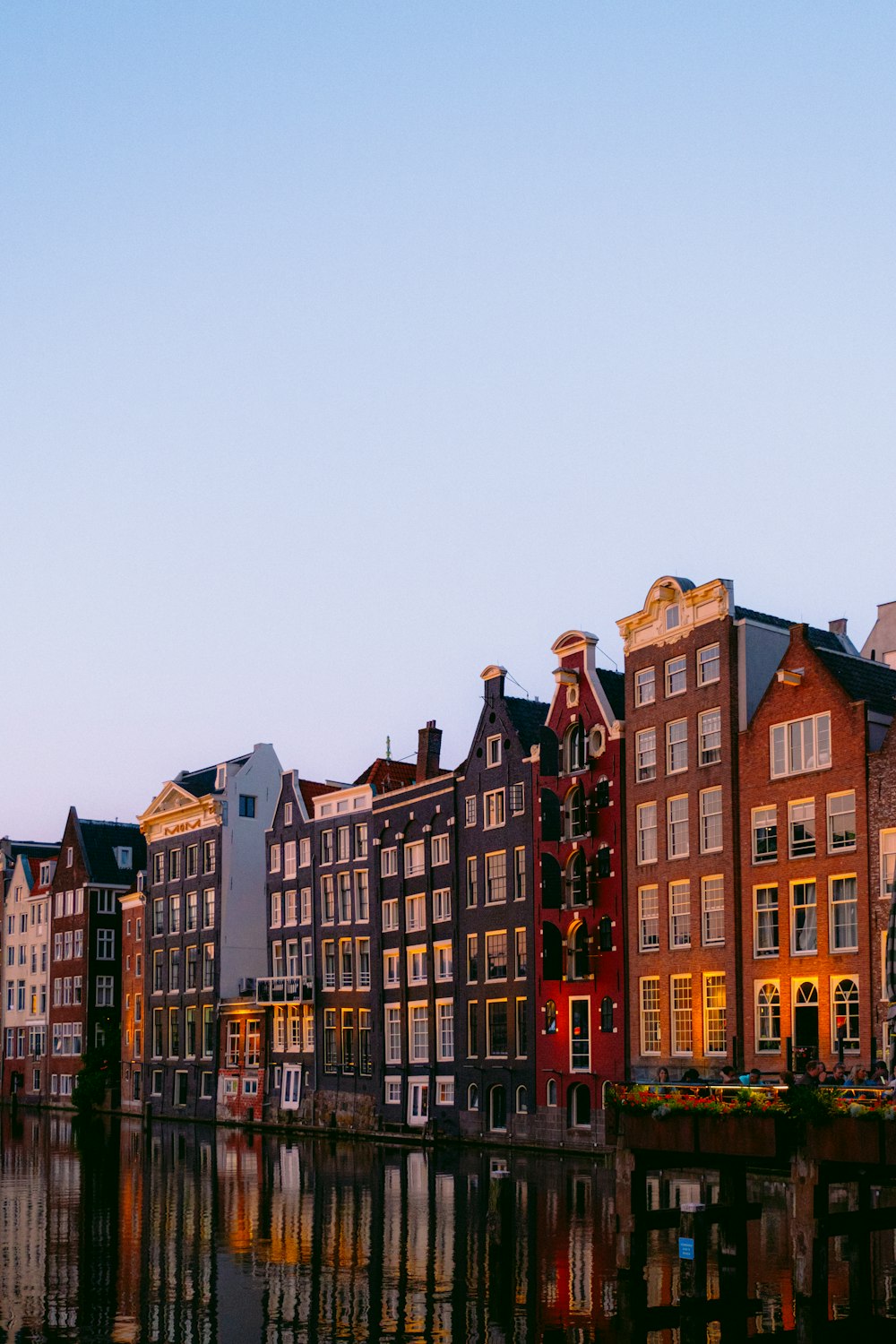 a row of buildings next to a body of water