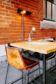 A solar LED wall lamp in a cozy outdoor seating area.