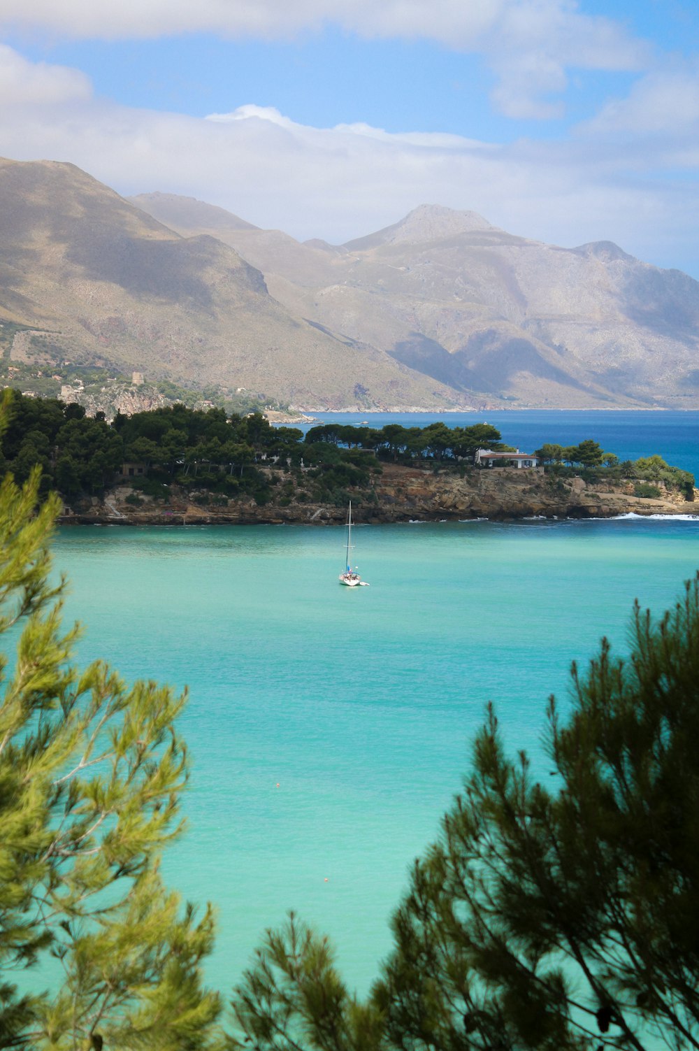 a view of a body of water with mountains in the background