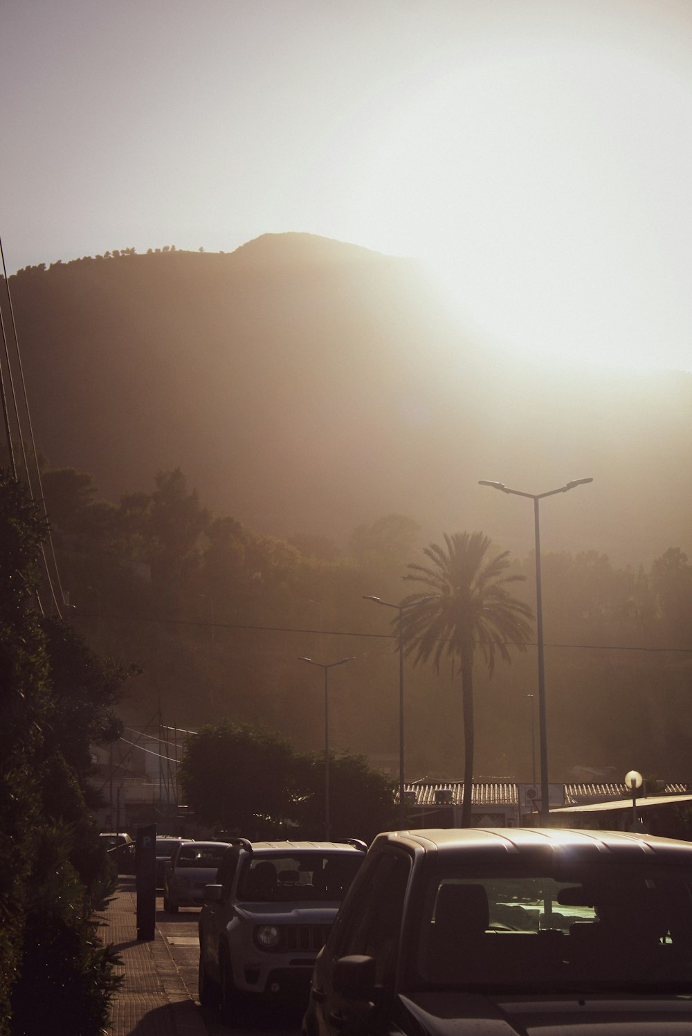 the sun is setting over the mountains in the distance