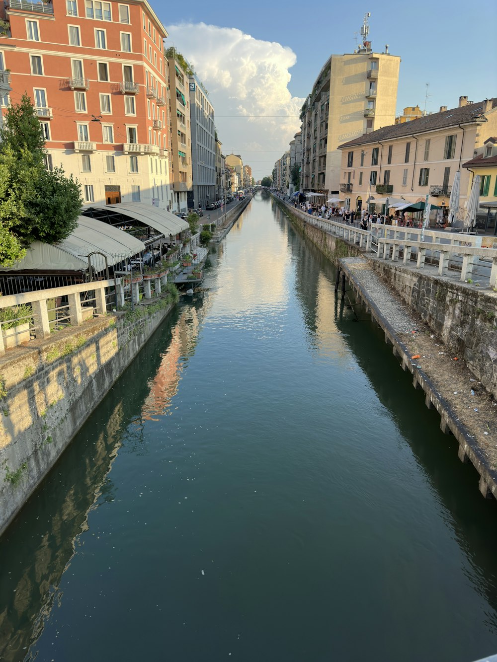 a river running through a city next to tall buildings