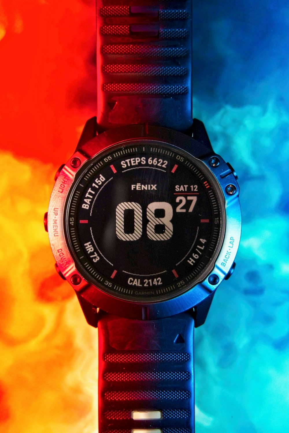 a close up of a watch on a colorful background