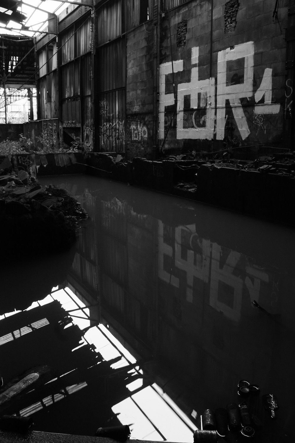 a black and white photo of a building with graffiti on it