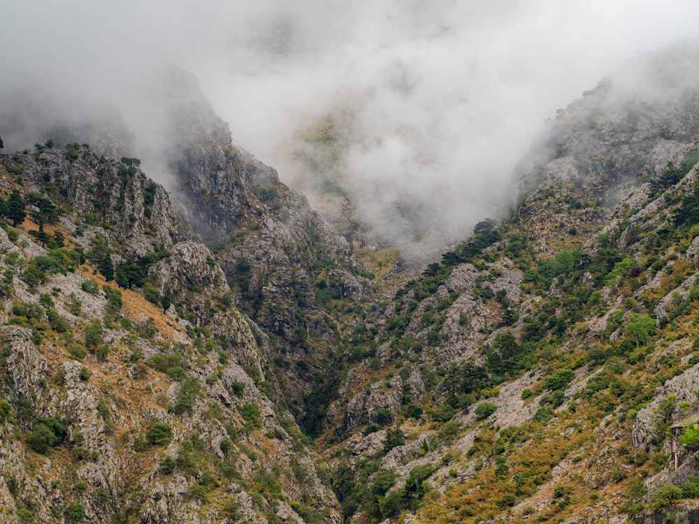 a view of a mountain with low lying clouds