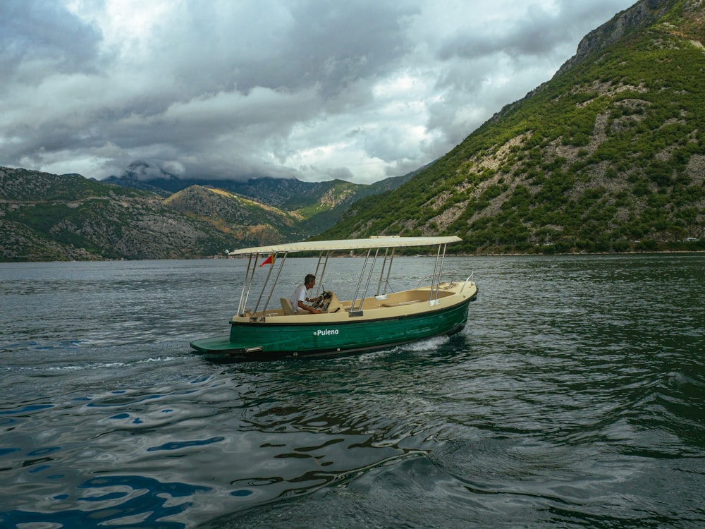 a small green boat on a large body of water