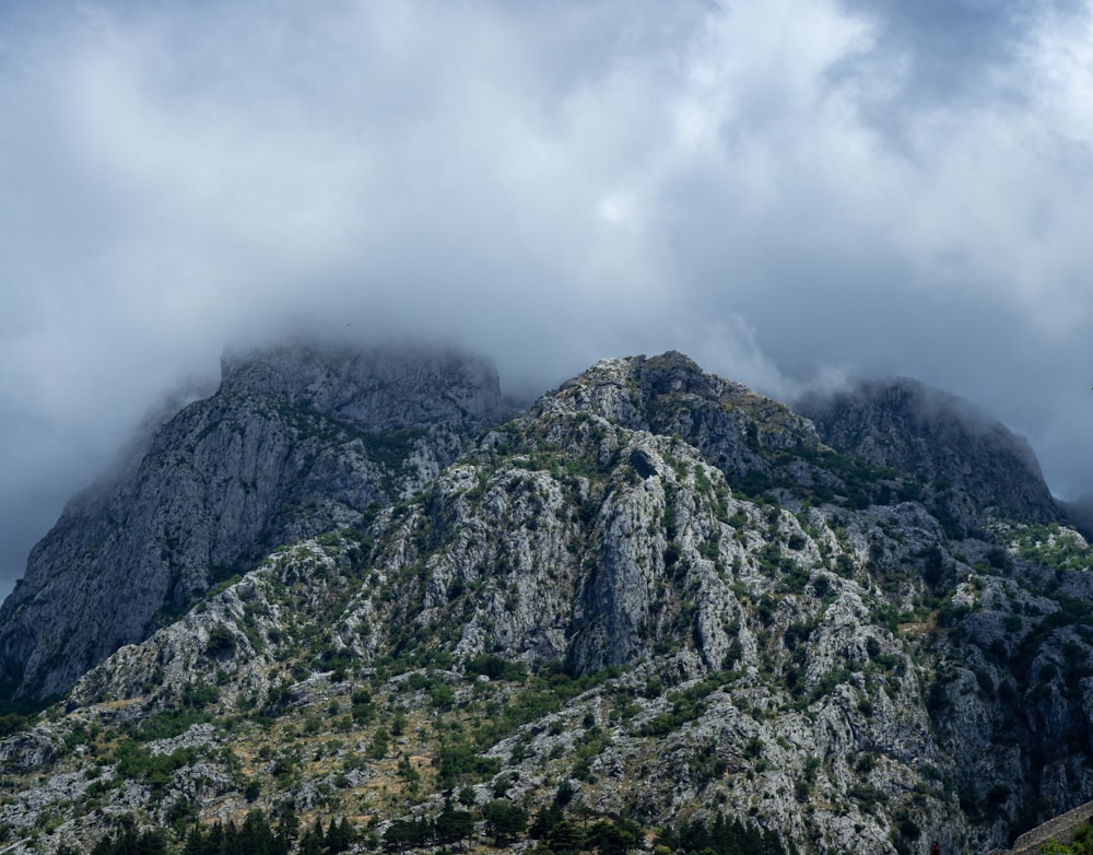 a very tall mountain with some clouds in the sky