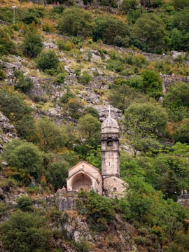 A rustic old church in Saint-Gervais surrounded by greenery.