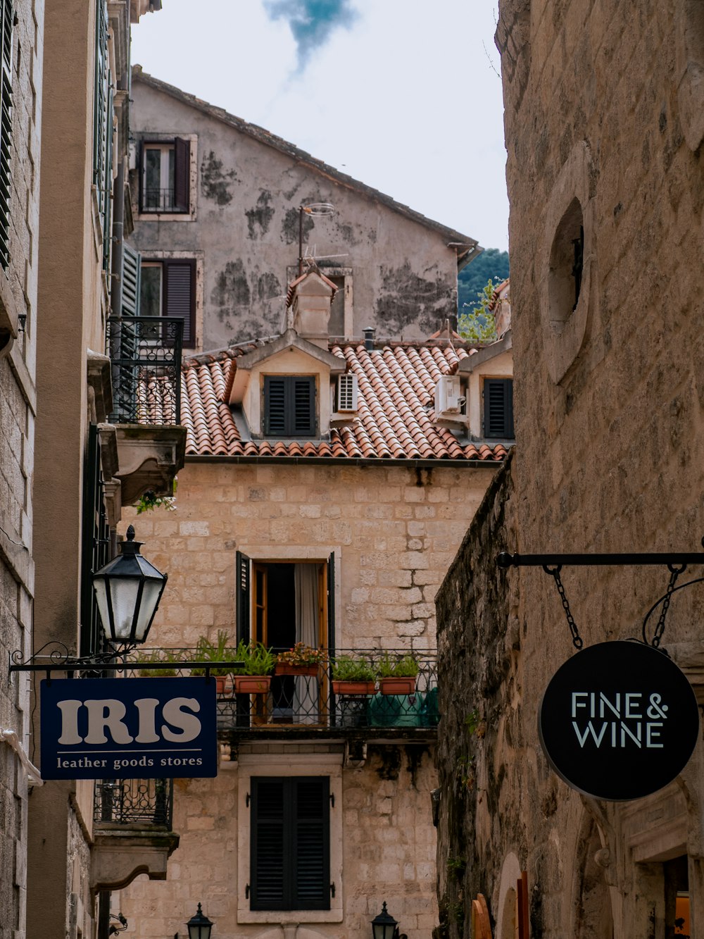 a street sign hanging from the side of a building