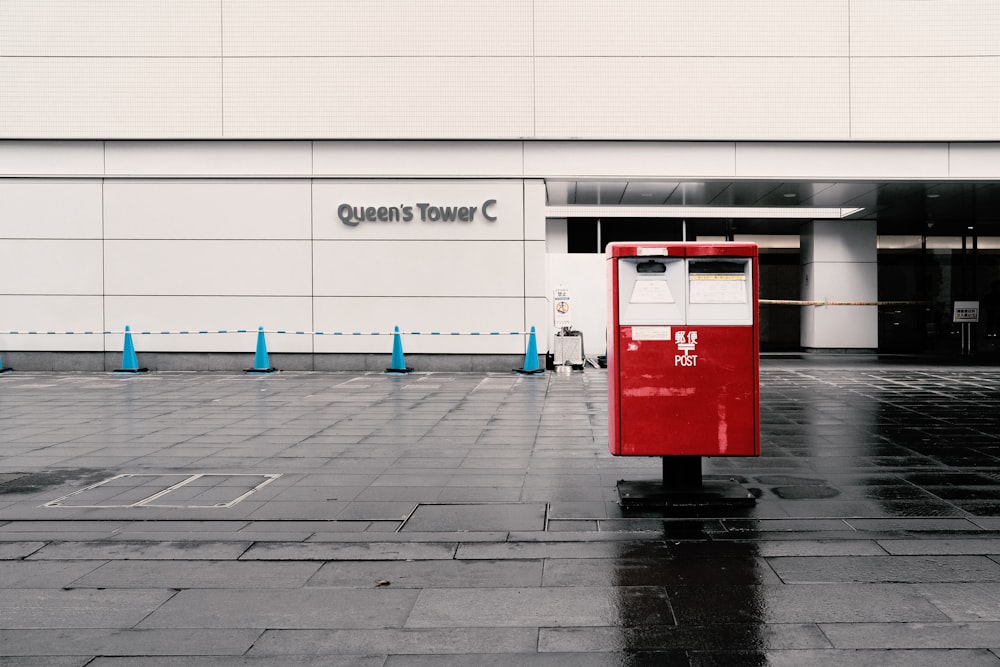 a red mailbox sitting in front of a building