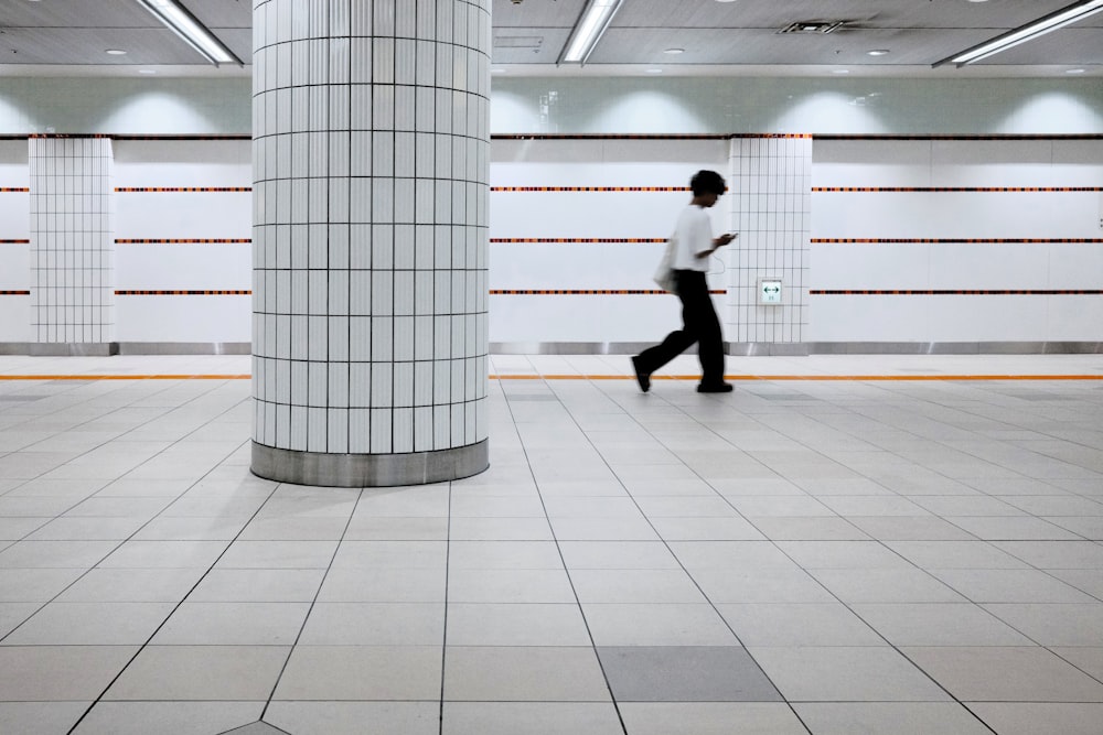 a man is walking through a large room