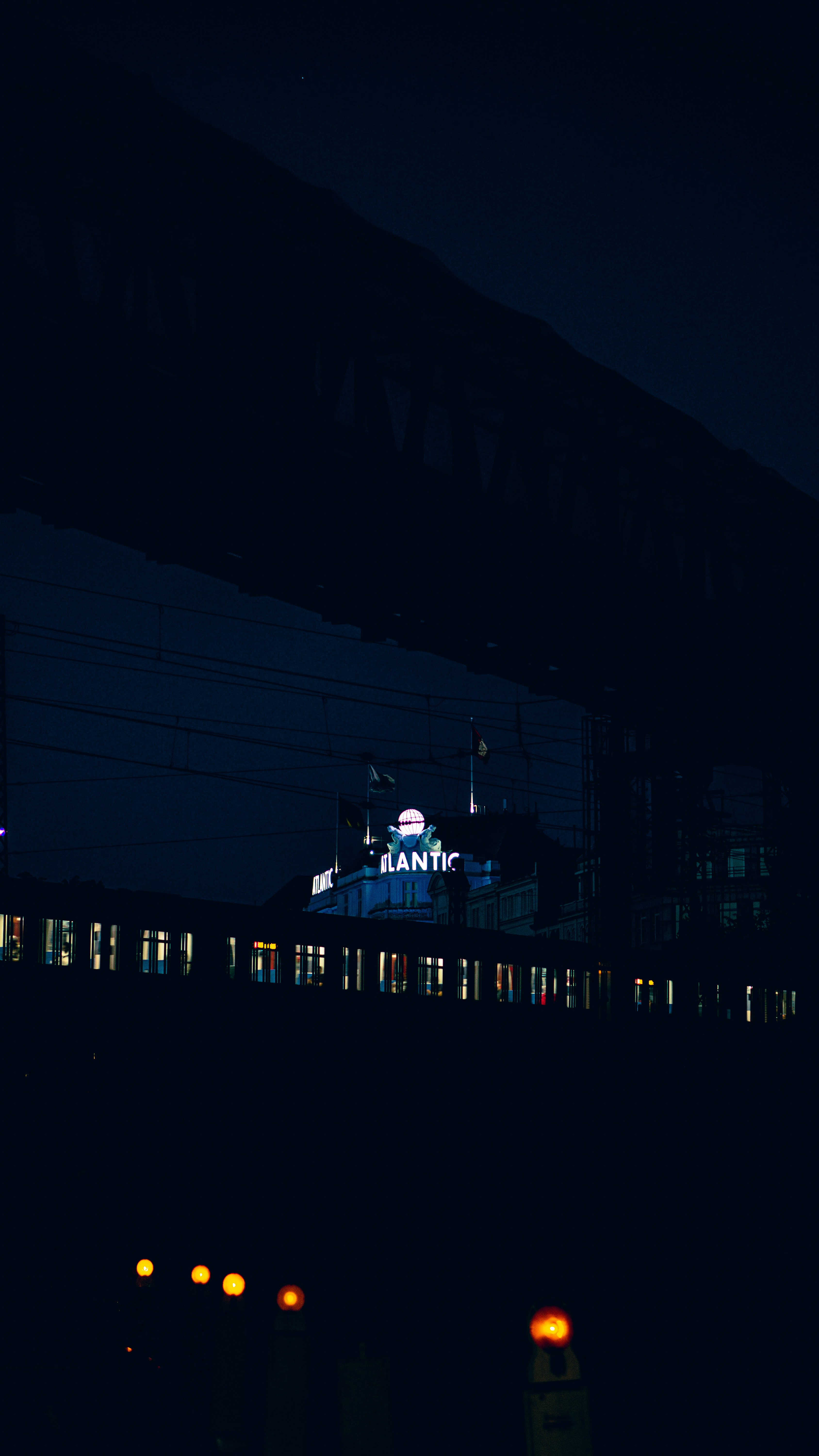 a train traveling past a train station at night
