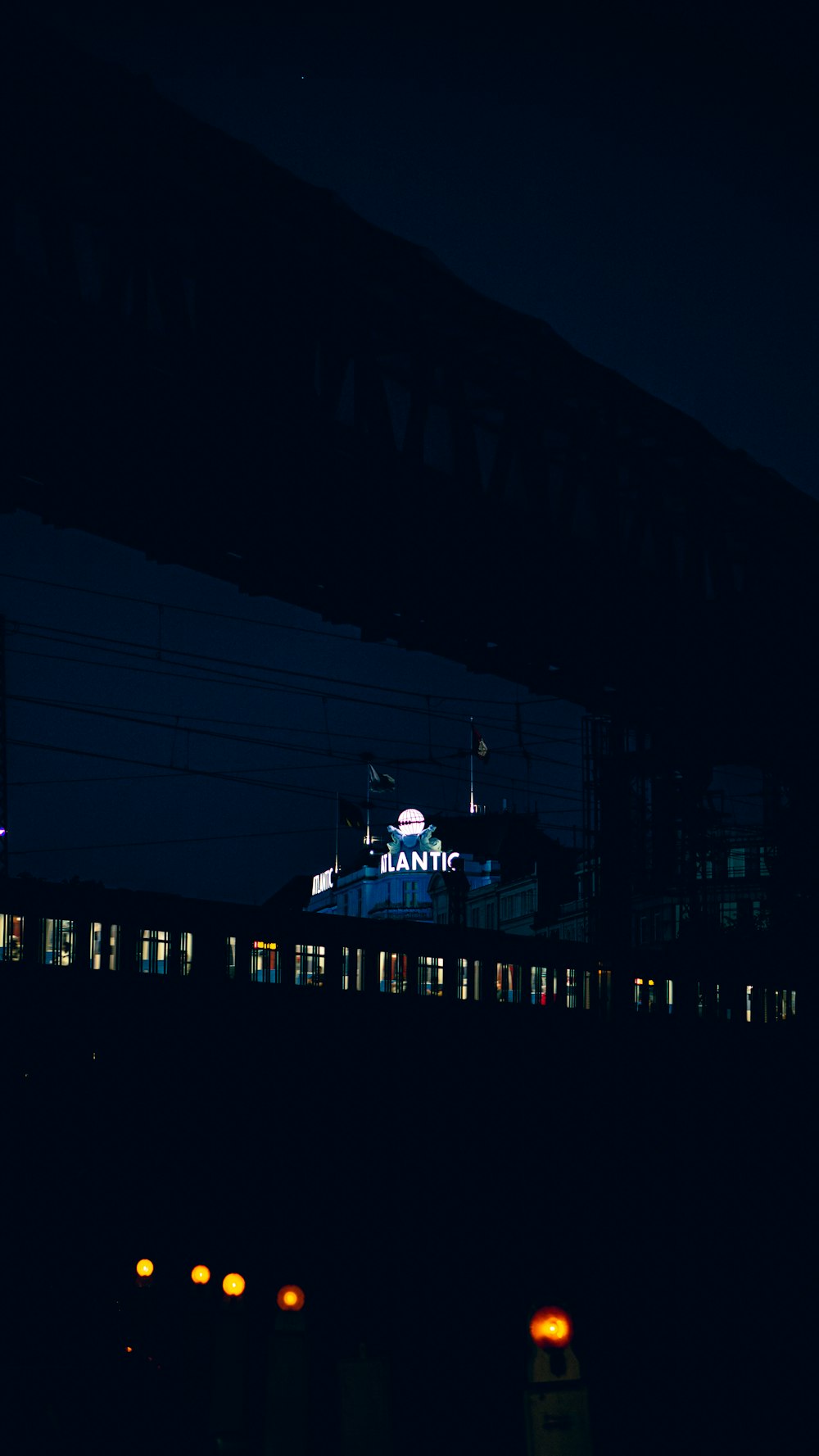 a train traveling past a train station at night