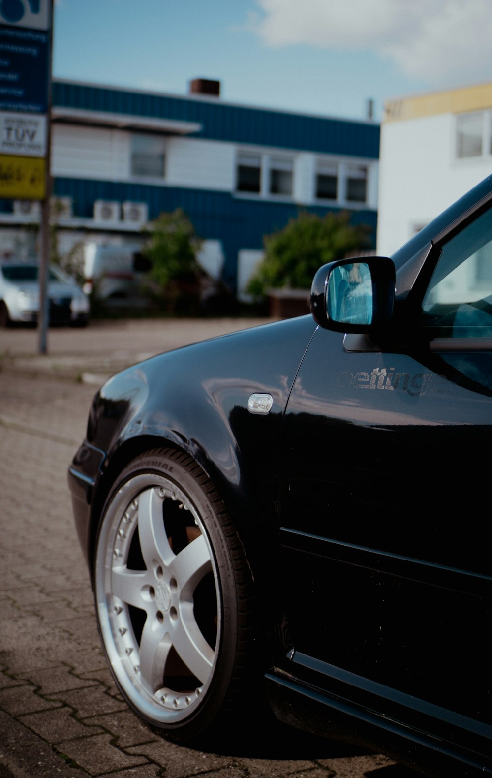 a black car parked in front of a building