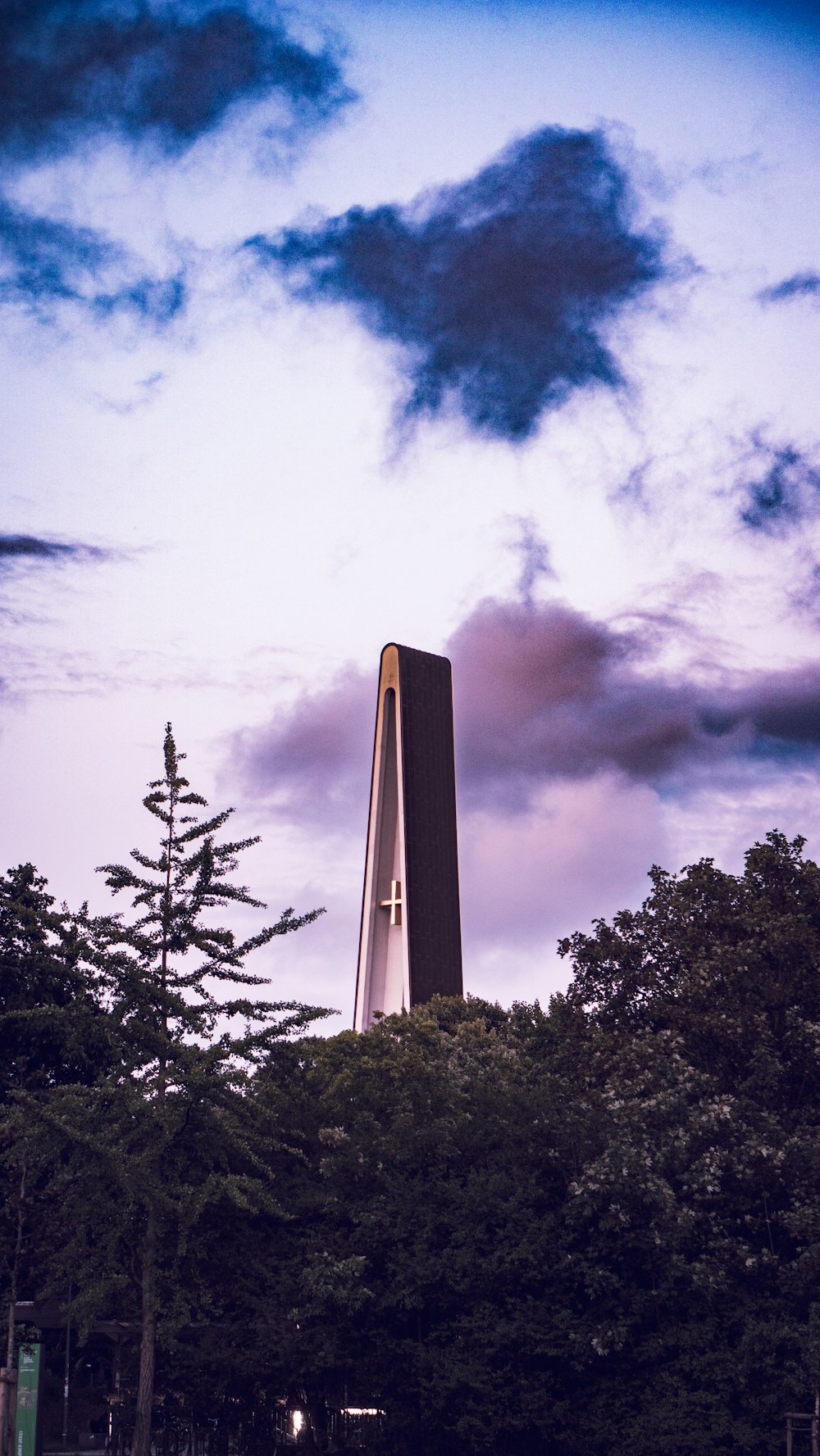 a tall tower with a cross on top of it