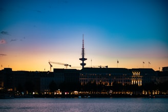 A sleek cityscape of Dubai with telecom towers and fiber optic cables glowing at dusk.