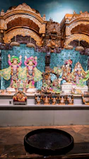 A serene altar adorned with vibrant god statues, incense, and traditional pooja items.