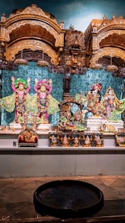 A vibrant altar decorated with flowers, goddess statues, and incense smoke curling upward.